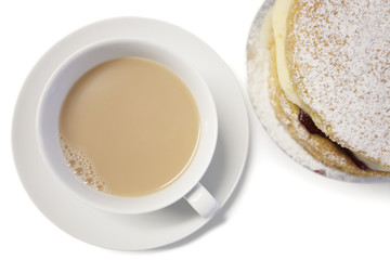 High angle view of tea cup and powdered sugar cake slice
