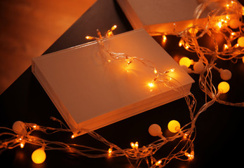 Book and beautiful garland on table