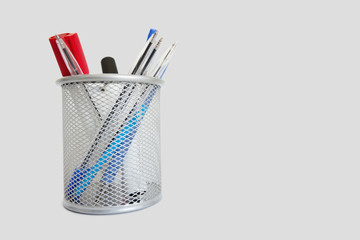 Close-up view of a pen holder over white background