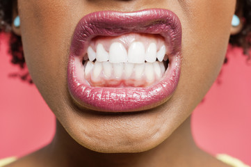 Cropped image of woman clenching teeth