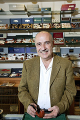 Portrait of a mature tobacco shop owner