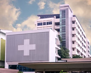 Fotobehang hospital building with big symbolic at cloudy day © whatamiii