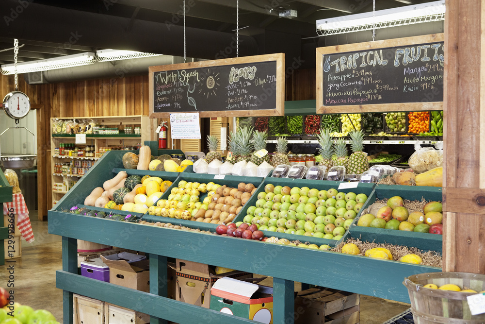 Wall mural Fresh fruits stall with text on blackboard in supermarket