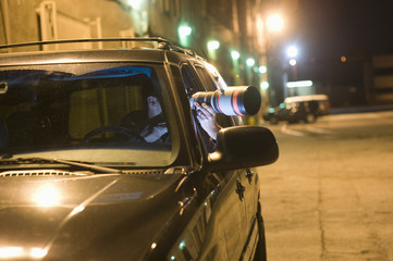 Naklejka premium Professional photographer with telephoto lens in car