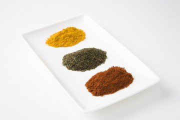 Chilli and turmeric with green tea in tray isolated over white background
