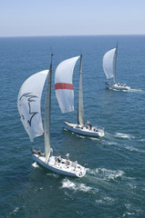 Obraz premium View of three yachts competing in team sailing event