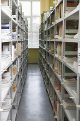 Obraz premium Aisles in university library with shelves full of books