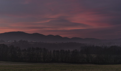 Sunrise under Milesovka hill in winter