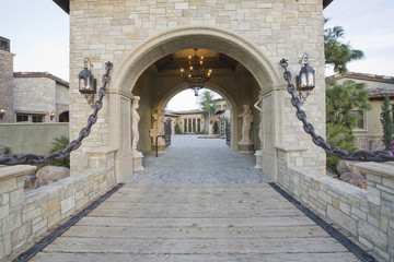 Stone gateway with arched structure to modern home