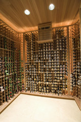 View of racks with wine bottles at domestic wine cellar
