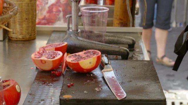 Squeezing fresh pomegranate juice.