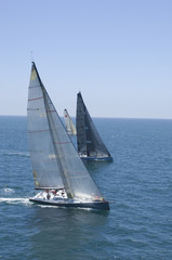 View of three yachts competing in team sailing event