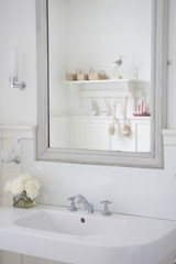 Gray painter mirror above bathroom sink