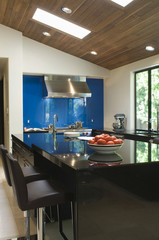 Blue backsplash and breakfast bar in modern kitchen