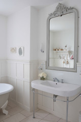 Gray painter mirror above bathroom sink