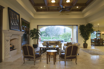 Spacious living room with view of porch and dining area in background at home