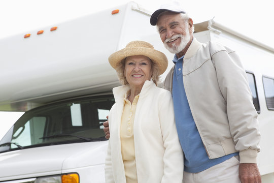 Portrait of a happy Senior couple and RV home