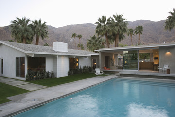 View of swimming pool and modern home exterior against mountains