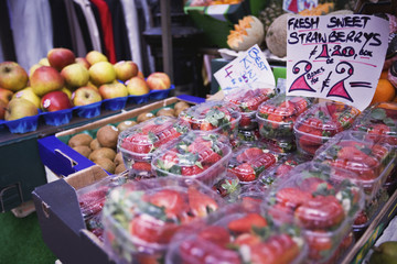 Fresh strawberries in plastic boxes on sale at farmer's market