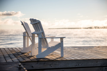 Adirondack Muskoka chairs on the dock at sunrise