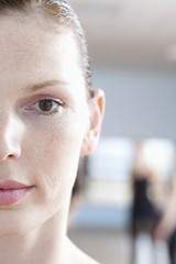 Closeup portrait of beautiful young woman in ballet rehearsal room