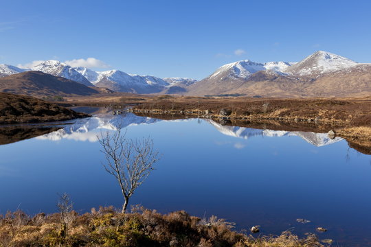 Snow covered mountains left to right Stob a'choire Odhair, Aonach Mor, Beinn Mhic Chasgaig, and Meall a'Bhuirudh, around Lochan na h-Achlaise lower Rannoch Moor, Argyll and Bute, Highlands