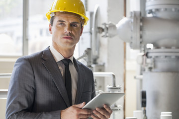 Portrait of young male architect holding tablet computer in industry