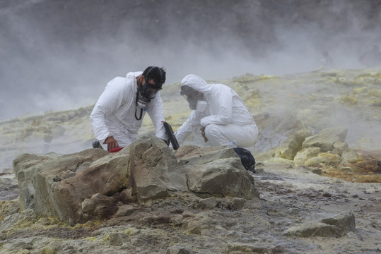 Geologists taking mineral samples on Gran Cratere (The Great Crater), Vulcano Island, Aeolian Islands, Sicily, Mediterranean