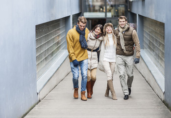 Full length of young friends on walkway