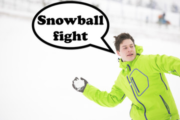 Young man in hooded jacket throwing snowball