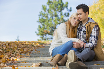 Fototapeta premium Loving couple sitting on park steps