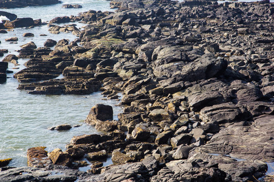 Waves break on the rocky beaches of Arambol in India.