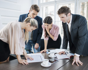 Young business people brainstorming at conference table in office