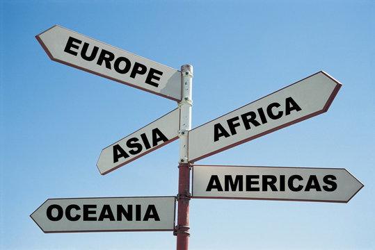 5 continents of the world on a sign post