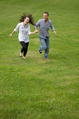 Young couple running in park