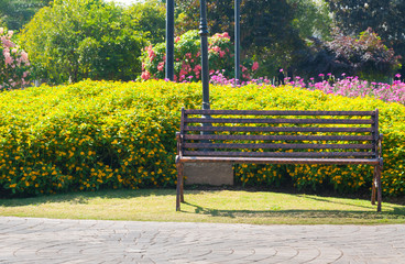 Lonely metal Decorative bench in the flower garden
