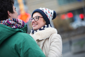 Romantic couple looking at each other in city during winter