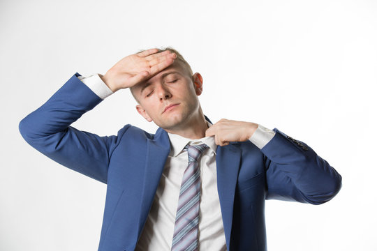 Businessman adjusting his collar as he feels hot