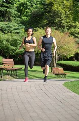 Obraz premium Multi ethnic couple running in park