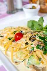 Pasta with pesto sauce and nuts on a the table