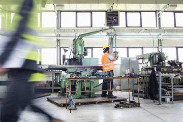 Manual worker operating machinery at metal industry