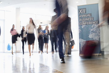 Fototapeta premium Blurred motion of business people walking in convention center
