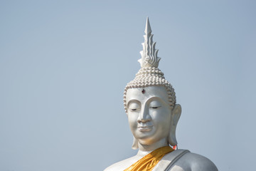 Obraz premium The White buddha status on blue sky background , Thailand