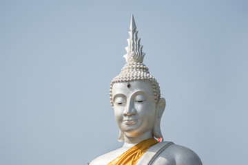Fototapeta premium The White buddha status on blue sky background , Thailand