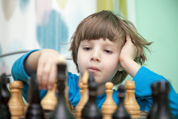Portrait of a boy playing chess