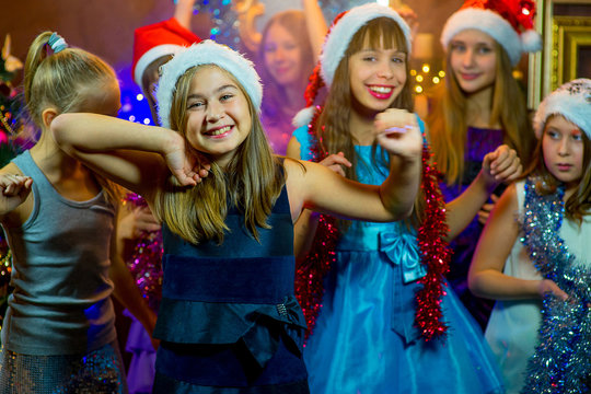 Group of young girls celebrating Christmas. First plan