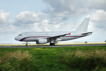 white airplane moves along the Runway
