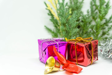 Gift box with present wrapped in kraft paper and with golden light beige bow isolated on the white background, gift ribbon bow knot.