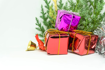 Gift box with present wrapped in kraft paper and with golden light beige bow isolated on the white background, gift ribbon bow knot.