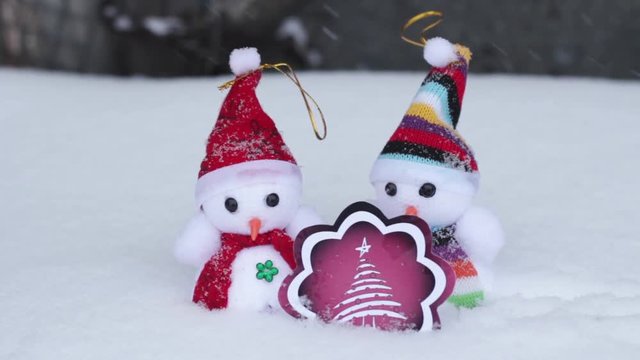 Winter snowmen and red fir-tree